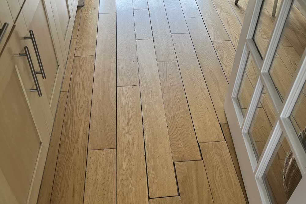 water damaged oak floor in kitchen welwyn- before