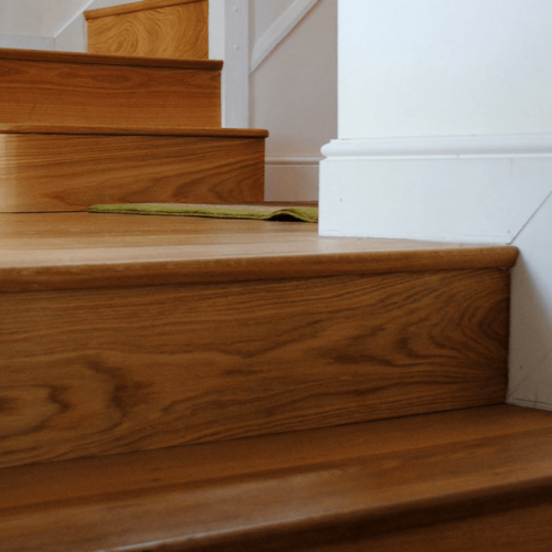 Standard softwood staircase given facelift by cladding with engineered Oak boards, finished with a solid Oak nosing to match.